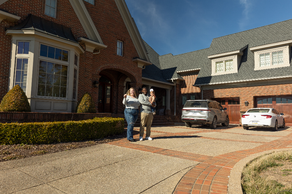 Couple infront of their new home